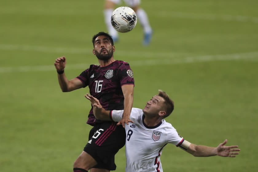 Mexico's Jose Esquivel, heads the ball challenged by United States' Djordje Mihailovic during a Concacaf Men's Olympic Qualifying championship soccer match in Guadalajara, Mexico, Wednesday, March 24, 2021. (AP Photo/Fernando Llano)