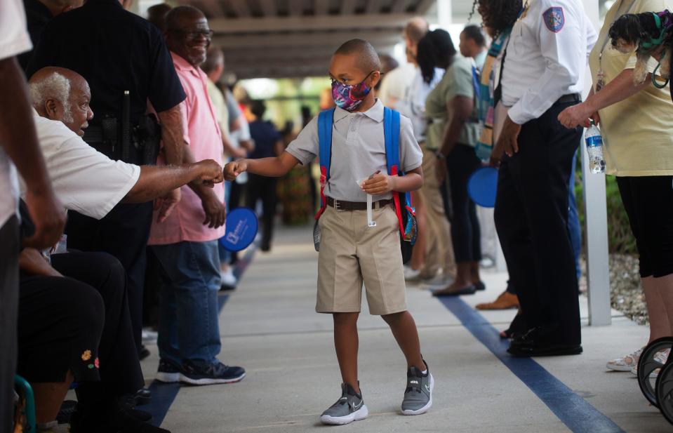 Incoming Franklin Park Elementary School student, King Boston is greeted by James Middlebrooks during the Gentleman’s Welcome on Wednesday, August 10, 2022. It was the first day of school for Lee and Collier County public schools.  Community leaders held a welcoming party for incoming students.  