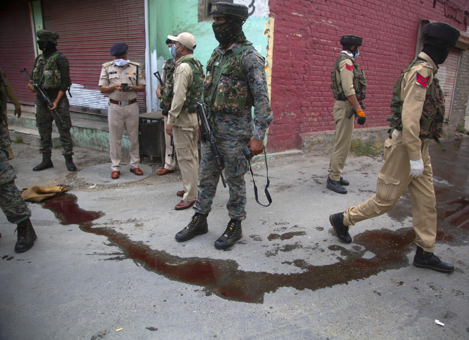 Indian policemen secure the area after suspected rebels attack on policemen on the outskirts of Srinagar, Indian controlled Kashmir, Friday, Aug. 14, 2020. Anti-India rebels in Indian-controlled Kashmir Friday attacked a police party in the disputed region's main city, killing two police officials and injuring another, police said. (AP Photo/Mukhtar Khan)