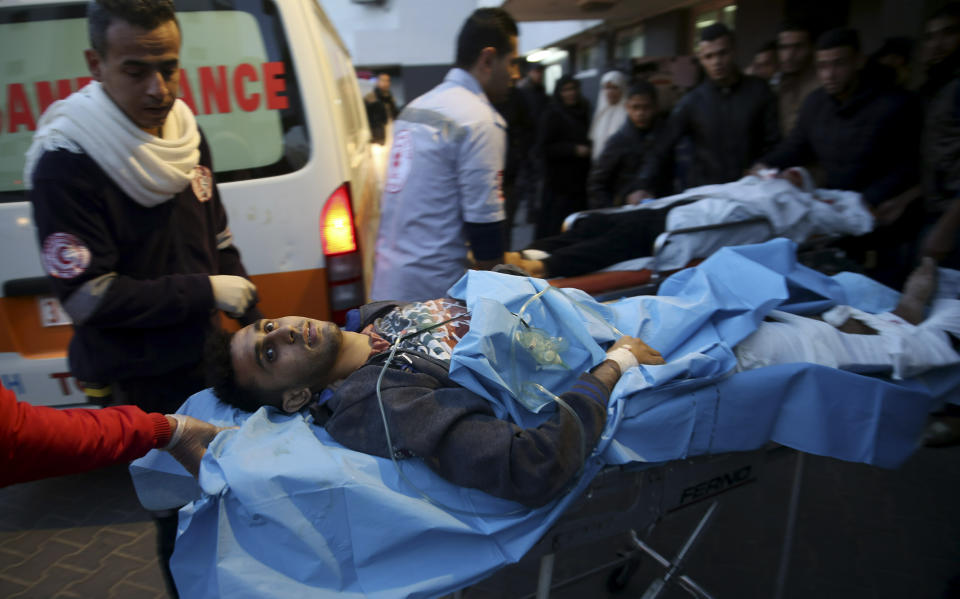 Palestinian medics a wounded youth, who was shot by Israeli troops during a protest at the Gaza Strip's border with Israel, into the treatment room of Shifa hospital in Gaza City, Friday, Jan. 11, 2019. (AP Photo/Adel Hana)