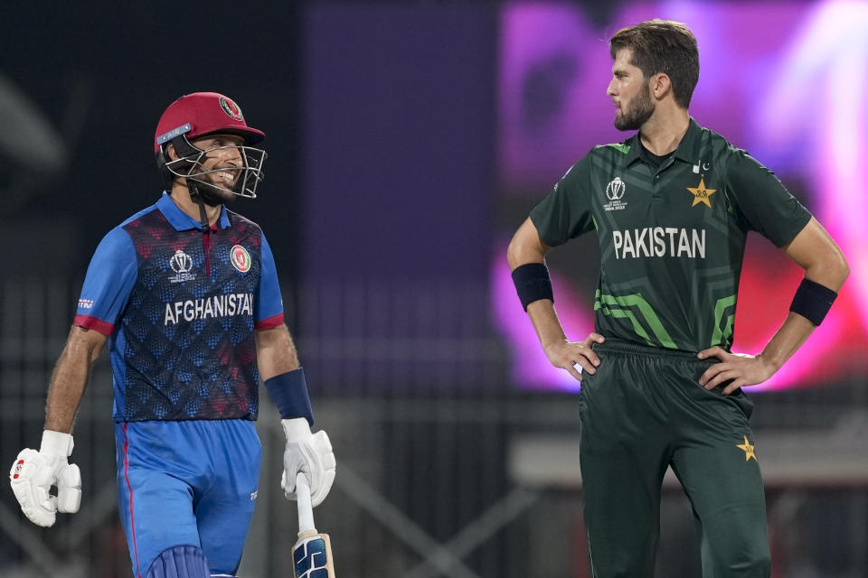 Afghanistan's Rahmat Shah smiles as he walks past Pakistan's Shaheen Afridi while batting during the ICC Men's Cricket World Cup match between Pakistan and Afghanistan in Chennai, India, Monday, Oct. 23, 2023. (AP Photo/Eranga Jayawardena)