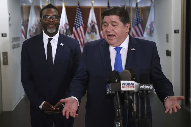 Johnson (left) and Democratic Illinois Gov. J.B. Pritzker speak to the media after meeting on Friday. Pritzker, who was officially neutral in the race, had been criticized by Vallas.