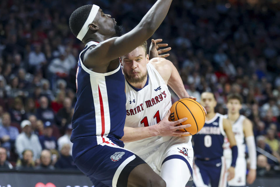 Saint Mary's center Mitchell Saxen (11) collides with Gonzaga forward Graham Ike (13) during the first half of an NCAA college basketball game for the championship of the West Coast Conference men's tournament Tuesday, March 12, 2024, in Las Vegas. (AP Photo/Ian Maule)