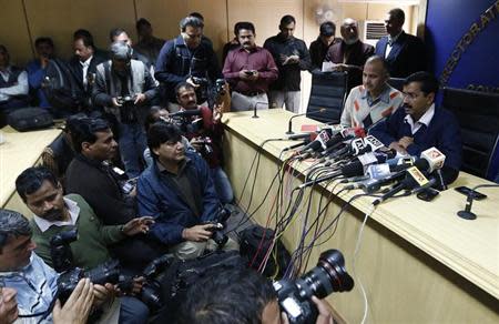 Delhi's Chief Minister Arvind Kejriwal (R), chief of the Aam Aadmi (Common Man) Party (AAP), addresses the media during a news conference in New Delhi February 11, 2014. REUTERS/Adnan Abidi