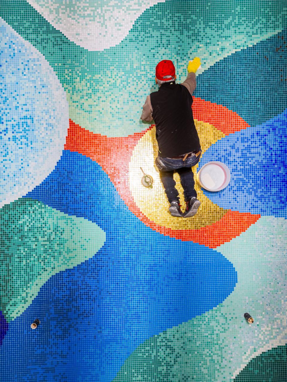 Bisazza artisan Marcello Fabrizi putting some final touches on the mosaic.