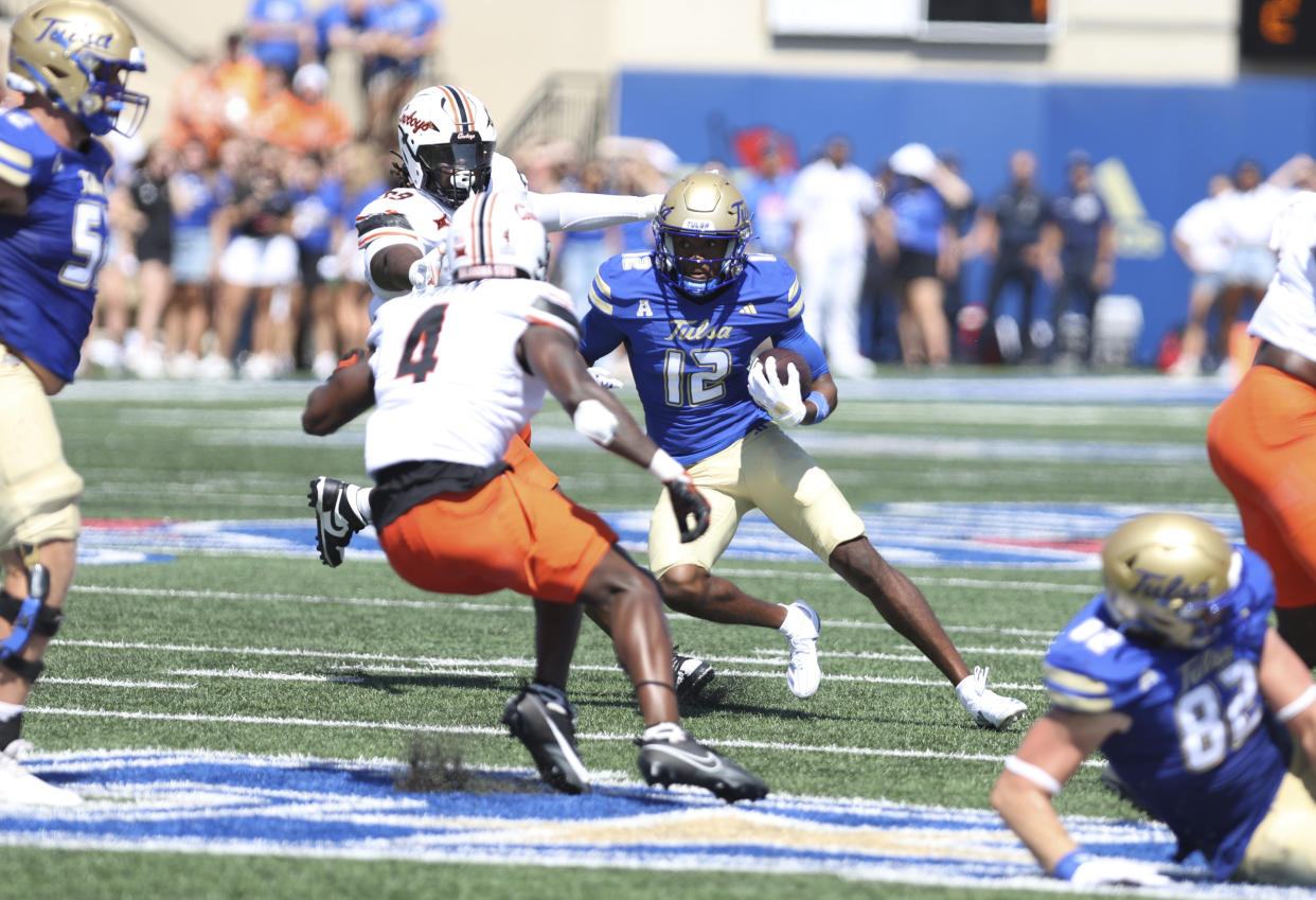 Tulsa wide receiver Corey Smith (12) looks for running room against Oklahoma State during the first half of an NCAA college football game, Saturday, Sept. 14, 2024, in Tulsa, Okla. (AP Photo/Joey Johnson)