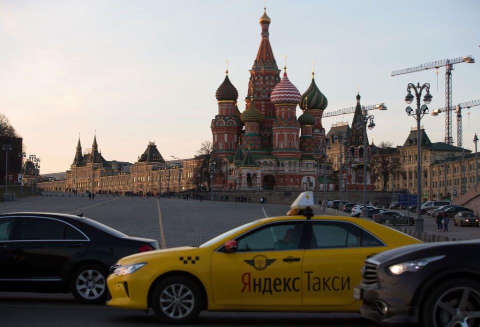 A yellow Yandex taxi cab waits for customers beside Red Square and Saint Basil's Cathedral in Moscow, Russia, on April 9, 2018. (Andrey Rudakov/Bloomberg via Getty Images)