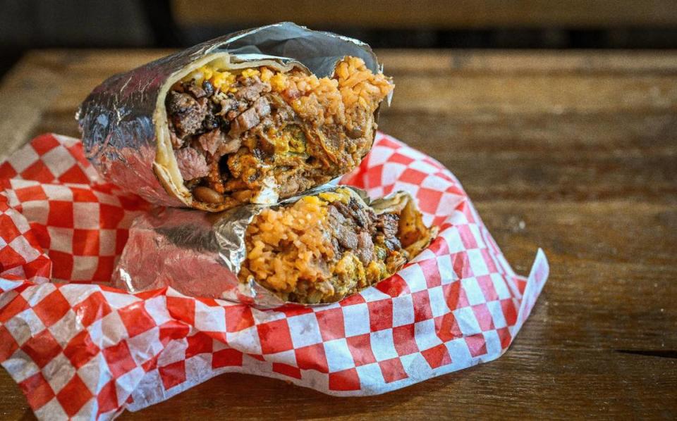 The Violin on Fire BBQ burrito, named for local musician Patrick Contreras, comes filled with smoked tri-tip, brisket, Spanish rice, Bernardo jalapeño bombs, chili beans and cheese at BenSmokin BBQ, in Fresno on Wednesday, July 12, 2023.