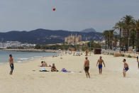 In this May 25, 2020 photo, people visit the beach in Palma de Mallorca, Spain. Spain's Balearic Islands will allow for thousands of German tourists to fly in from June 15 for a two-week trial of tourism under new regulations against the spread of the new coronavirus. (Isaac Buj/Europa Press via AP)