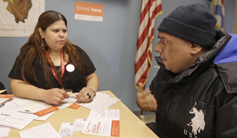 In this Feb. 3, 2014, photo, Yuvania Maldonado, an In Person Counselor for President Obama's new health care law speaks with taxi driver Mohammad Chaudri at a city office where Chicago taxi drivers go to renew their license. As the March 31 enrollment deadline creeps closer, the law’s supporters know they won’t get far boosting the so-far disappointing numbers if they stay in their state agencies and nonprofit headquarters. Instead, they’re fanning out, strategically hitting places where they can mine rich veins of uninsured during the limited time left. Cab drivers, restaurant workers, artists and community college students are seen as fertile ground.(AP Photo/M. Spencer Green)