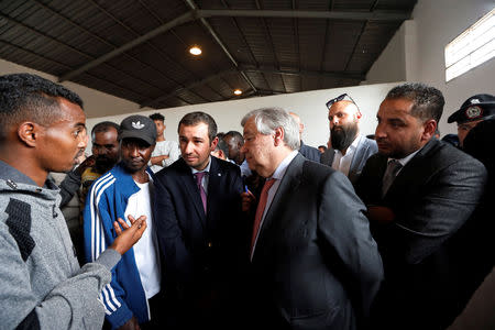 Secretary General of the United Nations Antonio Guterres listens to a migrant, as he visits a detention centre in Tripoli, Libya April 4, 2019. REUTERS/Ismail Zitouny