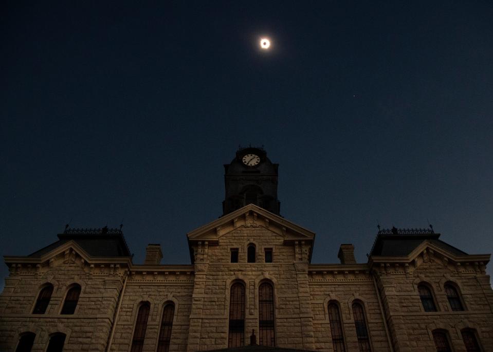 The total eclipse of the sun occurs over the historic Hood County Courthouse in Granbury Monday.