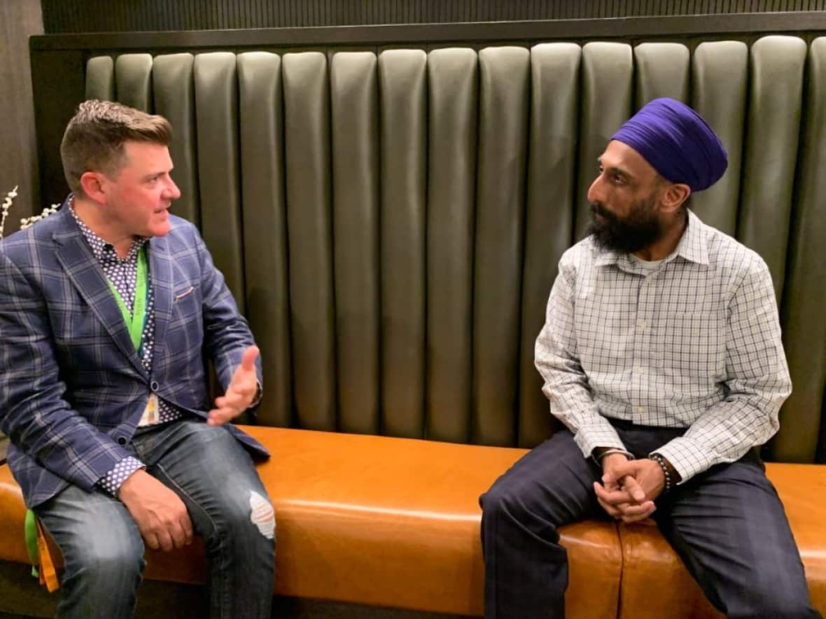 Dr. Robert Tanguay and Calgary Police Staff Sgt. Jas Kainth talk at The Newly Institute in Calgary in June 2022. (Brian Goldman/CBC News - image credit)