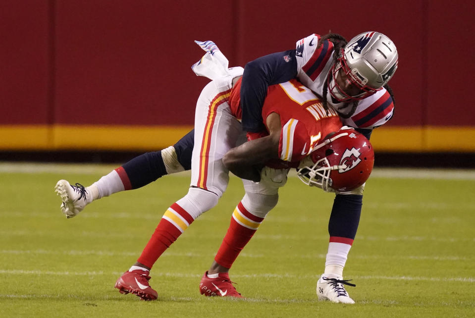 Kansas City Chiefs wide receiver Mecole Hardman is tackled by New England Patriots cornerback Stephon Gilmore, rear, during the second half of an NFL football game, Monday, Oct. 5, 2020, in Kansas City. (AP Photo/Charlie Riedel)