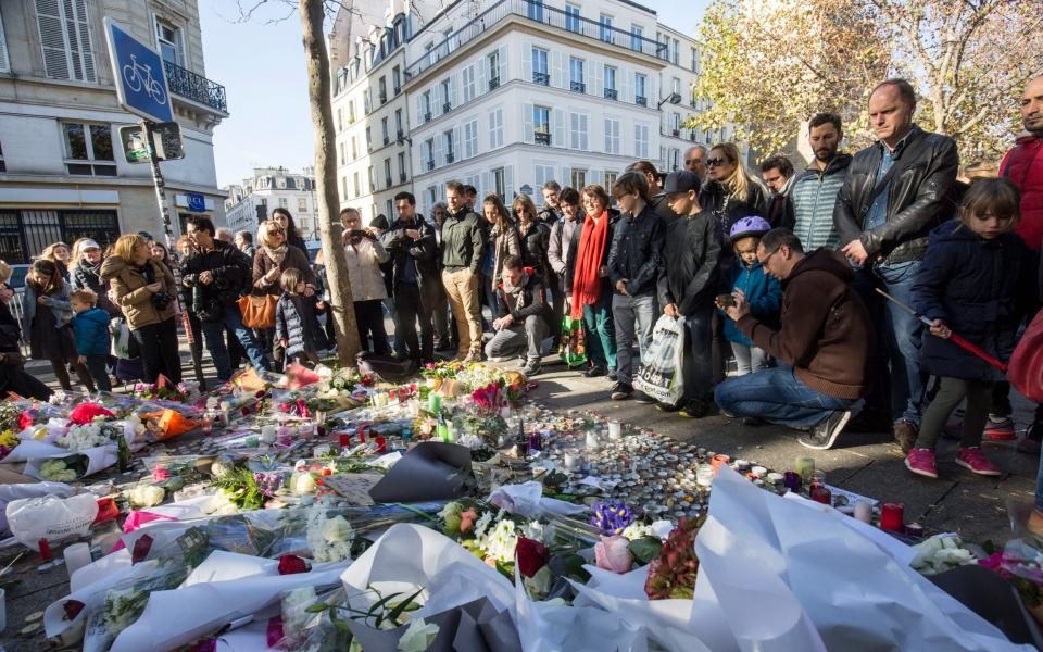 People gather in front of the memorial set near the Bataclan concert venue in Paris in November 2015 - JULIEN WARNAND 