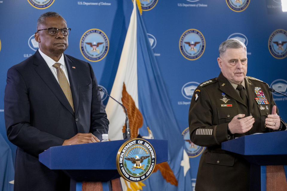 Chairman of the Joint Chiefs, Gen. Mark Milley, right, accompanied by Secretary of Defense Lloyd Austin, left, speaks during a briefing at the Pentagon in Washington, Wednesday, March 15, 2023. (AP Photo/Andrew Harnik)