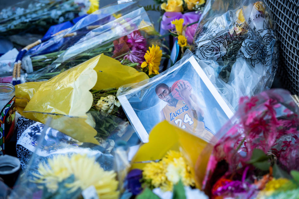 Crews behind a screened fence remove Kobe Bryant"u2019s memorial at L.A. Live on Monday, February 3, 2020 as a few scattered items are left in front of Staples Center. (Photo by Sarah Reingewirtz/MediaNews Group/Pasadena Star-News via Getty Images)