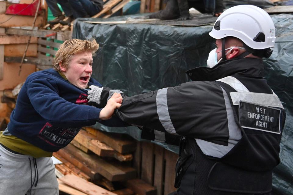 Bailiffs work to remove activists from their protest camp against the HS2, near Euston train station (AFP via Getty Images)