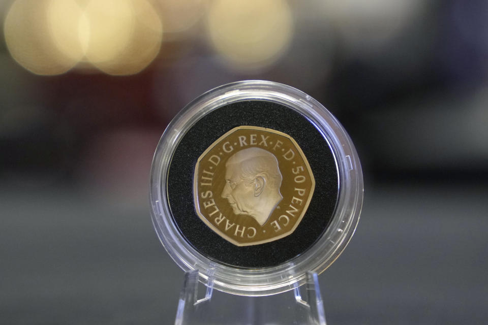 A 50p coin featuring the portrait of King Charles III, is displayed during the "Trial of the Pyx,'' a ceremony that dates to the 12th Century in which coins are weighed in order to make certain they are up to standard, at the Goldsmiths' Hall in London, Tuesday, Feb. 7, 2023. A jury sat solemnly in a gilded hall in central London on Tuesday, presided over by a bewigged representative of the crown in flowing black robes, but there were no criminals in the dock. (AP Photo/Kin Cheung)