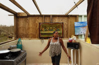 <p>Single mother Omayra Cruz, 44, returned from a food distribution with a box she would share with 4-year-old son Nene. But the two were still living without a roof, sleeping under the stars next to a pig pen, and a picture of the Last Supper. Their water tank had a few inches left. (Photo: Carolyn Cole/Los Angeles Times via Getty Images) </p>