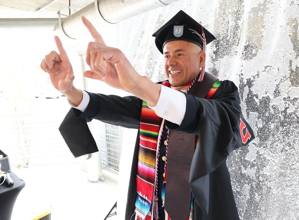 Moises Cook celebrates his masters degree while posing for a photo in a photo booth during the University of Utah’s commencement in Salt Lake City on Thursday, May 4, 2023. With 8,723 graduates, it is the largest group of graduates in the school’s history. | Jeffrey D. Allred, Deseret News