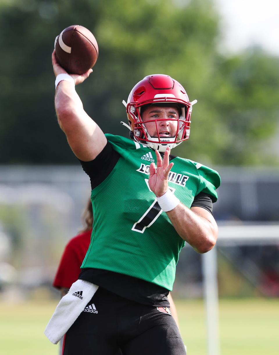 U of L QB Brock Domann (7) passes during practice on fan day outside Cardinal Stadium in Louisville, Ky. on Aug. 8, 2021.  
