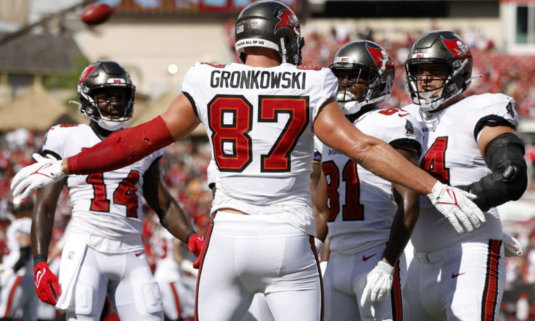 Rob Gronkowski embraces his Buccaneers teammates after scoring a touchdown.