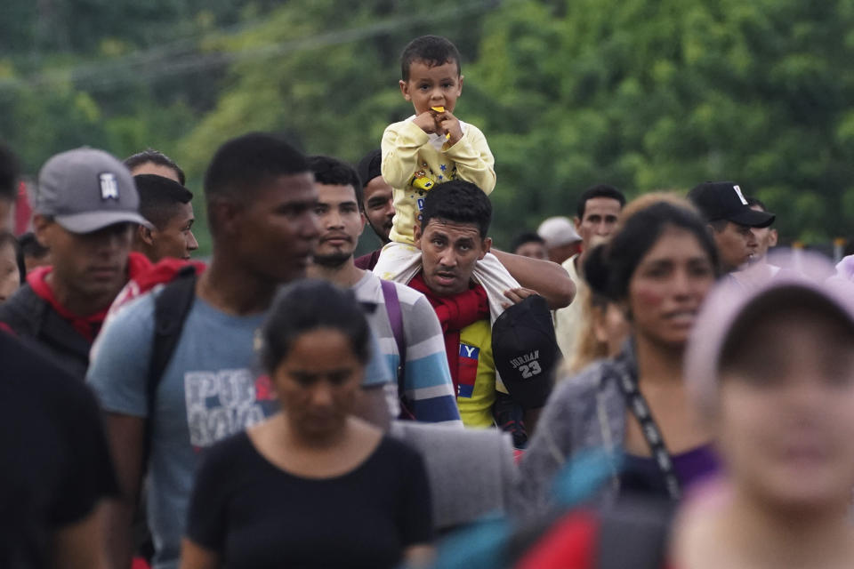 Migrants, many from Central American and Venezuela, walk along the Huehuetan highway in Chiapas state, Mexico, early Tuesday, June 7, 2022. The group left Tapachula on Monday, tired of waiting to normalize their status in a region with little work and still far from their ultimate goal of reaching the United States. (AP Photo/Marco Ugarte)