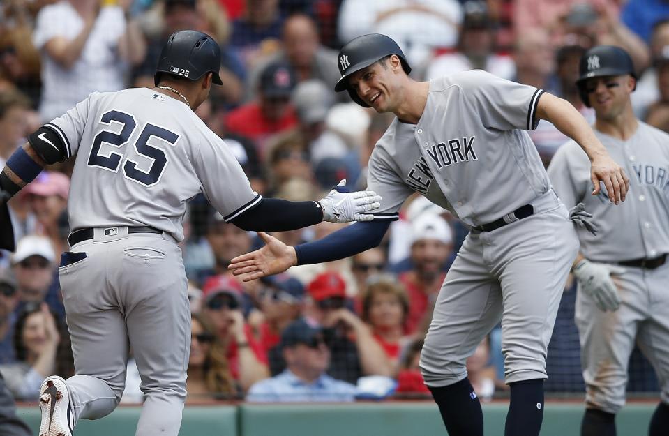 New York Yankees' Gleyber Torres (25) celebrates his two-run home run that also drove in Greg Bird, right, during the fourth inning of a baseball game against the Boston Red Sox in Boston, Saturday, Sept. 29, 2018. (AP Photo/Michael Dwyer)