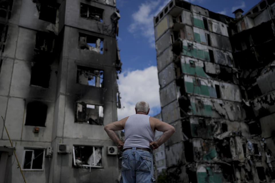 A man stands looking at a building destroyed during attacks, in Borodyanka, on the outskirts of Kyiv, Ukraine, Saturday, June 4, 2022. (AP Photo/Natacha Pisarenko)