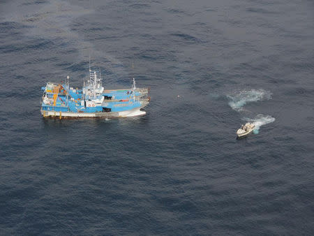 South Korean trawlers are seen along with a boat launched from Japan Coast Guard patrol vessel Bukou, after a South Korean trawler and a Japanese fishing boat collided in the Sea of Japan, in this handout photo taken November 15, 2018 and provided by Japan Coast Guard. 9th Regional Coast Guard Headquarters - Japan Coast Guard/Handout via REUTERS