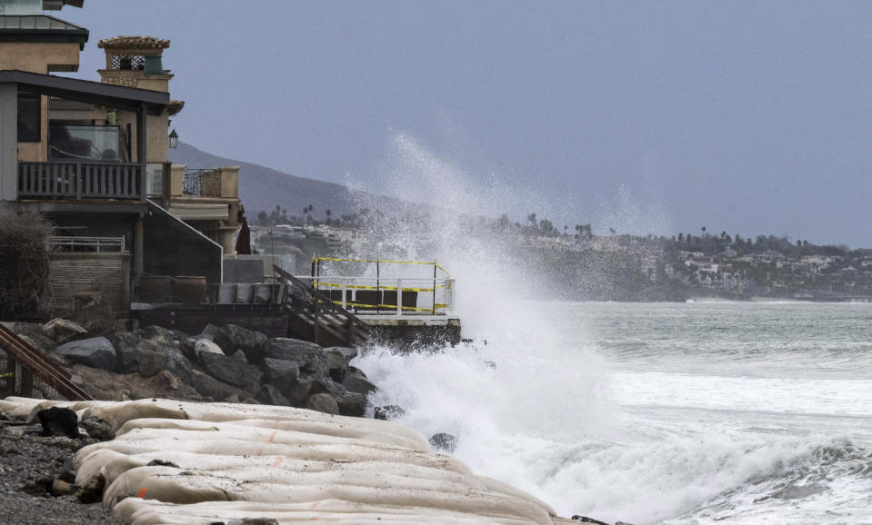 Waves crash into boulders in front of homes at Capistrano Beach in Dana Point, Calif., on Friday, Sept. 9, 2022. The remains of Tropical Storm Kay combined with the morning high tide brought the danger of further erosion to the area. (Paul Bersebach/The Orange County Register via AP)