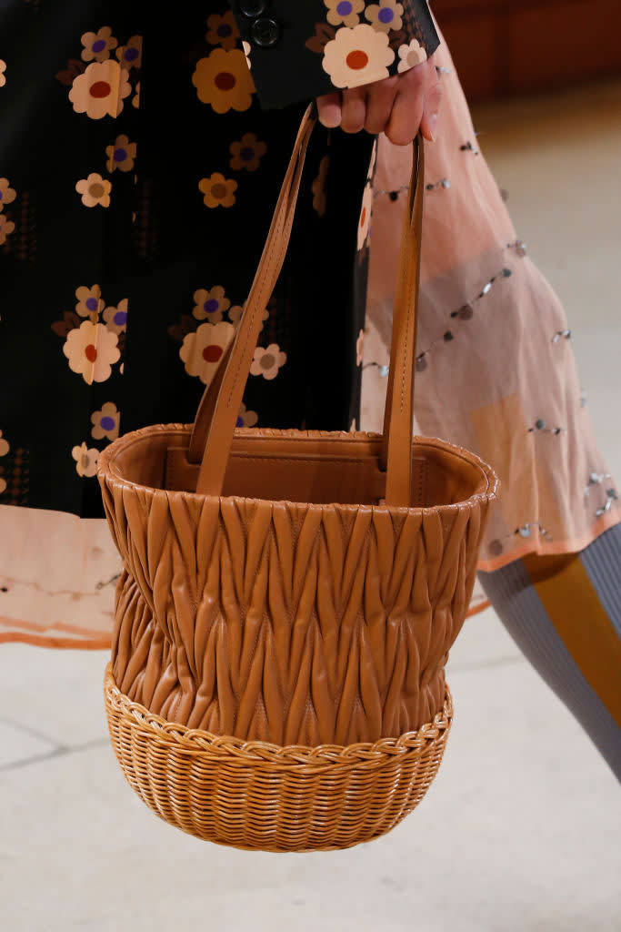 <p>A model carries a brown bucket basket bag during the Miu Miu spring/summer 2018 show in Paris. (Photo: Getty Images) </p>