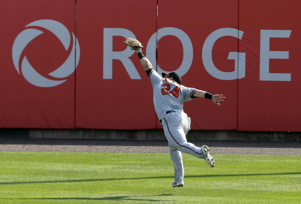 Baltimore Orioles outfielder DJ Stewart makes a leaping catch on Toronto Blue Jays Bo Bichette during the first inning of a baseball game, Sunday, Sept. 27, 2020, in Buffalo, N.Y. (AP Photo/Jeffrey T. Barnes)