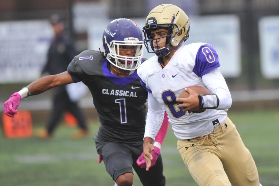 St. Raphael's Andre DePina-Gray tries to get away from Marquis Buchanan on this first-quarter run during a game last season.