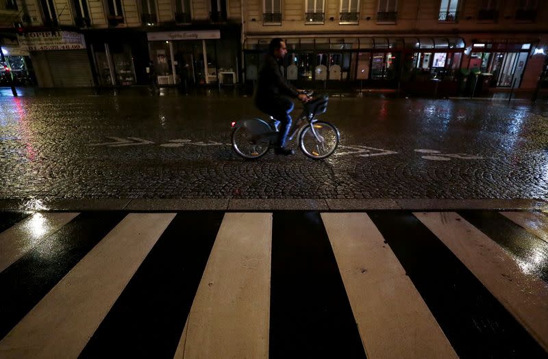 A man rides his bicycle as a strike by all unions of the Paris transport network and French SNCF workers entered its seventh consecutive day in Paris