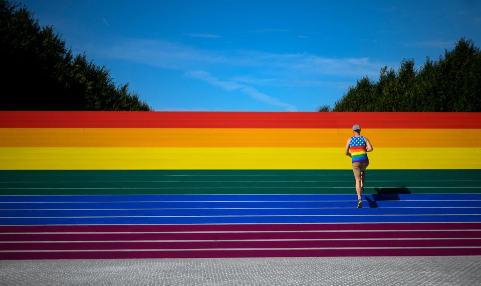A man walks on steps covered in rainbow colors for Pride Month at Franklin D. Roosevelt Four Freedoms Park on June 15, 2019 in New York City.
