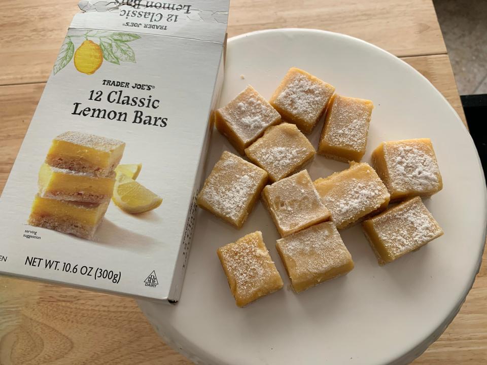 white plate of trader joe's lemon bars beside white box