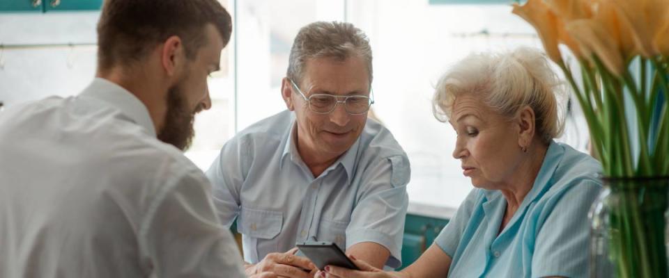 senior couple talking with their son