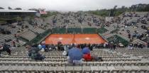 Tennis - French Open - Roland Garros - France - Paris, France - 30/05/16 Spectators use umbrellas to protect themselves from the rain. REUTERS/Gonzalo Fuentes