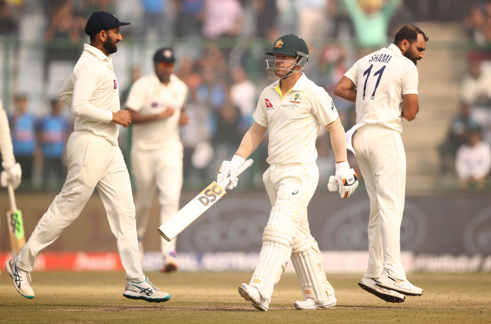 David Warner (pictured middle) walks off the field after being dismissed.