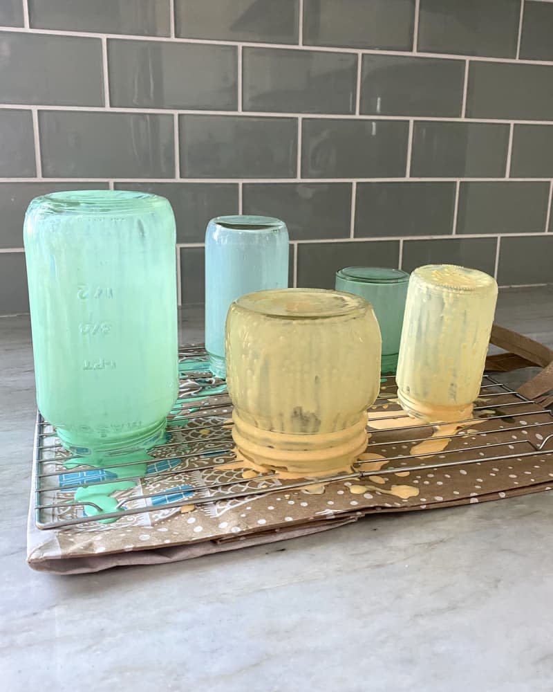 DIY vintage colored glass jars on rack drying