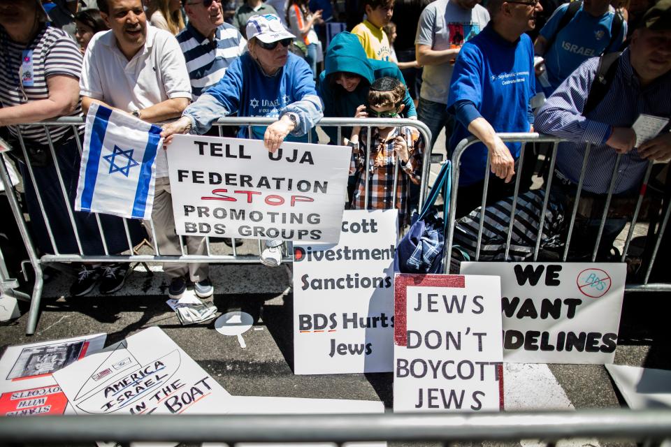 Protesters against the Boycott, Divestment and Sanctions movement stand behind a police barricade during the Celebrate Israel Parade in New York in 2014.