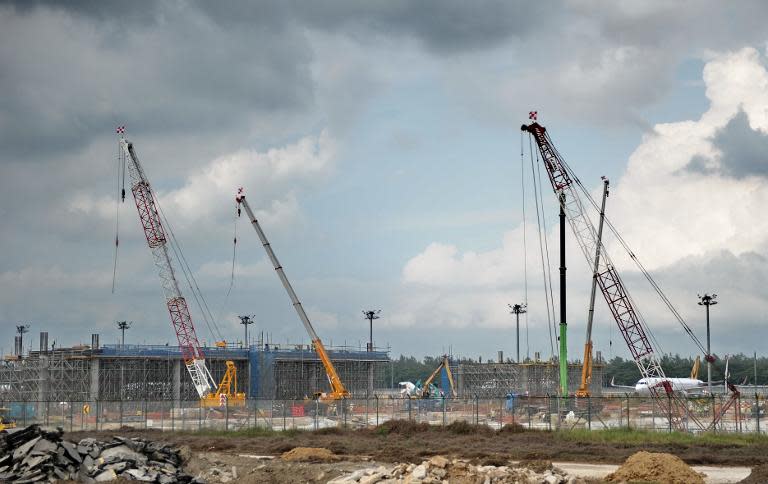 A building under construction next to the tarmac of Changi international airport in Singapore on July 23, 2104