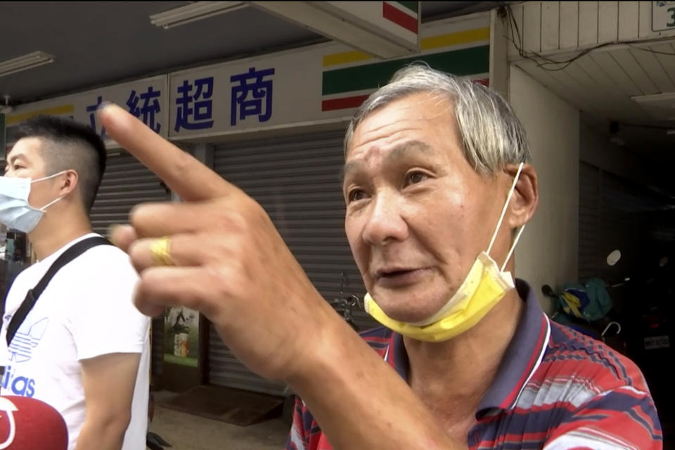 Local resident Lee Mao-sheng talks about his friend who died during a building fire in Kaohsiung in southern Taiwan on Friday, Oct. 15, 2021. Taiwanese officials set up an independent commission Friday to investigate the conditions at a run-down building in the port city of Kaohsiung where a fire killed dozens, while authorities scoured the blackened ruins for the cause of the blaze. (AP Photo/Wu Taijing)