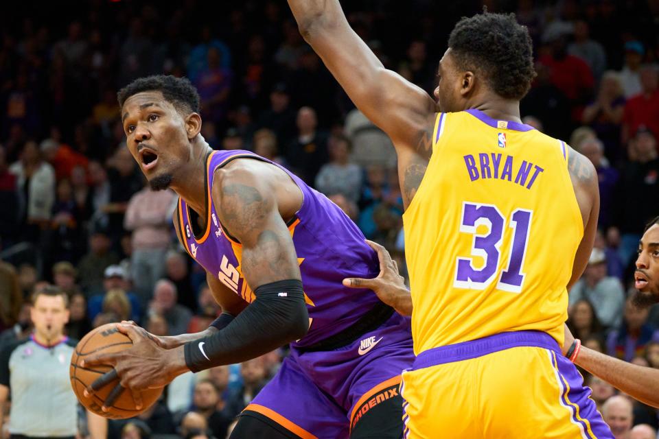 Dec 19, 2022; Phoenix, AZ, USA; Phoenix Suns center Deandre Ayton (22) looks to pass the ball while being pressured by Los Angeles Lakers center Thomas Bryant (31) at Footprint Center on Monday, Dec. 19, 2022. Mandatory Credit: Alex Gould/The Republic