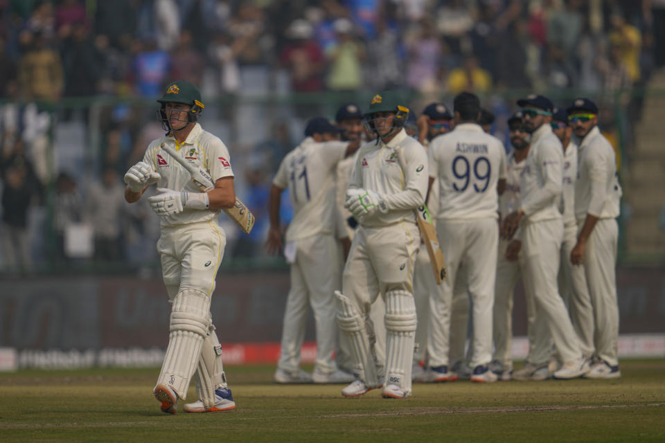 Australia's Marnus Labuschagne, left, walks back to pavilion after his dismissal during the first day of the second cricket test match between India and Australia in New Delhi, India, Friday, Feb. 17, 2023. (AP Photo/Altaf Qadri)