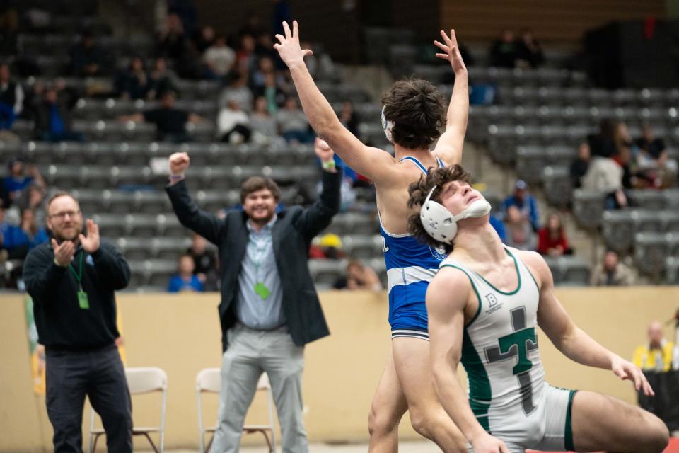 Oldham County’s Miller Brown celebrates his win over Trinity’s Ayden Lehman after the 150-pound state wrestling championship match.