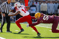 Nebraska running back Rahmir Johnson (14) breaks the tackle of Minnesota defensive lineman Val Martin (56) for a touchdown in the second quarter of an NCAA college football game Saturday, Oct. 16, 2021, in Minneapolis. Minnesota won 30-23. (AP Photo/Bruce Kluckhohn)