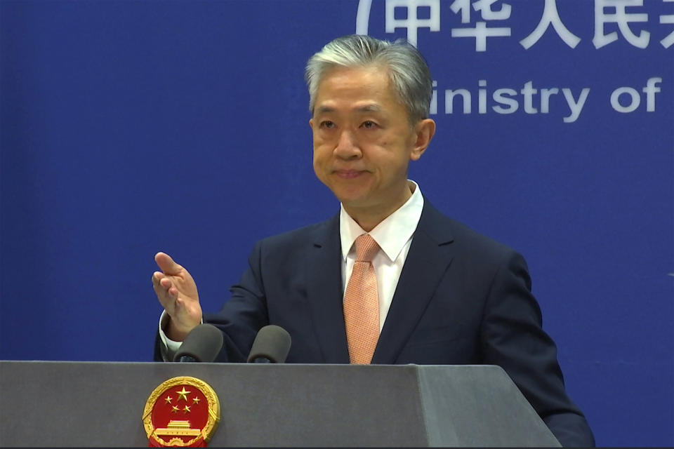 FILE - Chinese Foreign Ministry spokesperson Wang Wenbin reacts during the daily presser at the Ministry of Foreign Affiairs in Beijing, on May 27, 2022. After a U.N. report concluding that China's crackdown in the far west Xinjiang region may constitute crimes against humanity, China used a well-worn tactic to deflect criticism: blame a Western conspiracy. (AP Photo/Liu Zheng, File)